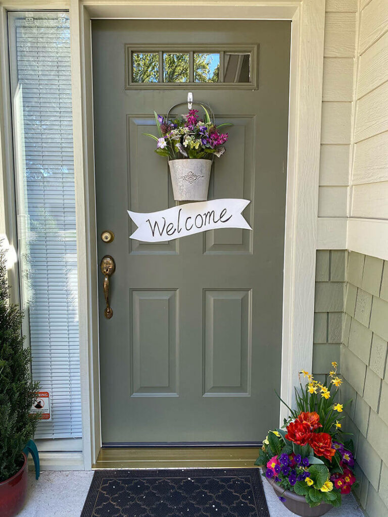 Front door with a welcome sign on it.